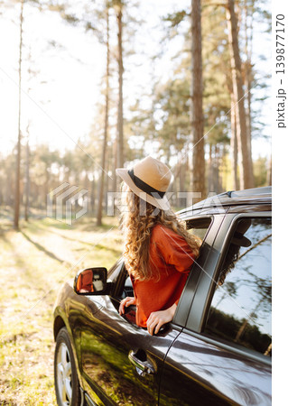 Happy woman in car window. Hair in wind. Road trip. Lifestyle, travel, tourism, nature, active life Happy woman in car window. Hair in wind. Road trip. Lifestyle, travel, tourism, nature, active life 139877170