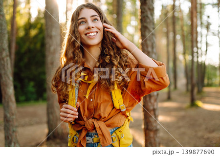 Stylish woman enjoying autumn weather in the park. Autumn mood. Hiking. Stylish woman enjoying autumn weather in the park. Autumn mood. Hiking. 139877690