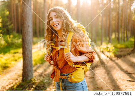 Stylish woman enjoying autumn weather in the park. Autumn mood. Hiking. Stylish woman enjoying autumn weather in the park. Autumn mood. Hiking. 139877691