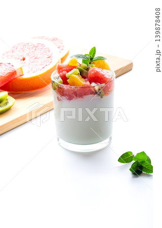fresh yogurt with fruit topping and grapefruit slice on white background 139878408