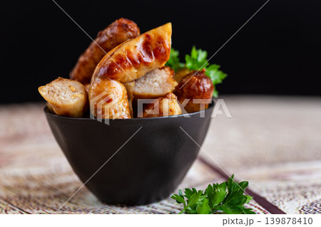 roasted meat sausages on dark background closeup scene roasted meat sausages on dark background closeup scene 139878410
