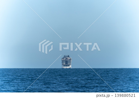 cruise ship far away in the middle of the sea 139880521