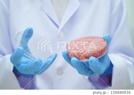 Scientist holding Petri dish with meat in science laboratory for food product development. Scientist holding Petri dish with meat in science laboratory for food product development. 139880916