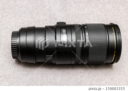 Professional Telephoto Zoom Camera Lens on Gray Surface Professional Telephoto Zoom Camera Lens on Gray Surface 139881353
