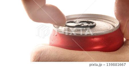 Cola or soda can opening. Close up of hand open aluminum beverage can with pull tab. Refreshing Cola or soda carbonated soft drink container with metal texture condensation droplets and easy open lid 139881667