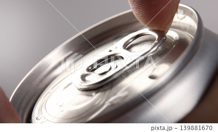 Cola or soda can opening. Close up of hand open aluminum beverage can with pull tab. Refreshing Cola or soda carbonated soft drink container with metal texture condensation droplets and easy open lid Cola or soda can opening. Close up of hand open aluminum beverage can with pull tab. Refreshing Cola or soda carbonated soft drink container with metal texture condensation droplets and easy open lid 139881670