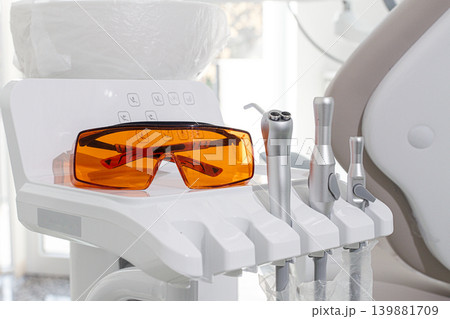 Dental instruments and safety glasses on the module, there are no people in the dental clinic Dental instruments and safety glasses on the module, there are no people in the dental clinic 139881709