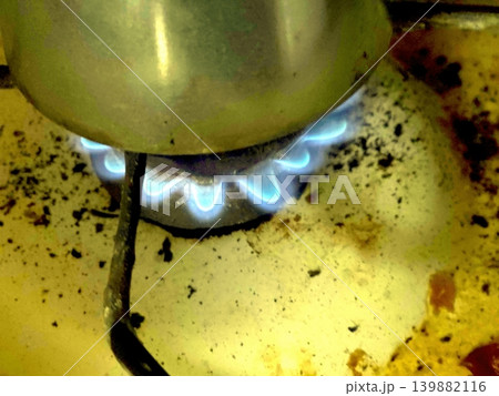 Flames on a Gas Camphor Burner During Cooking in a Kitchen Setting Flames on a Gas Camphor Burner During Cooking in a Kitchen Setting 139882116