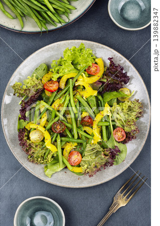 Colorful salad bowl with fresh greens and bean pods Colorful salad bowl with fresh greens and bean pods 139882347