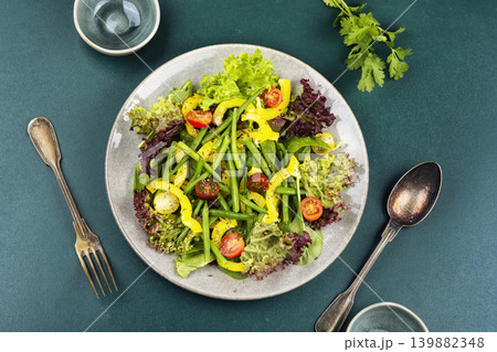 Organic green salad with bell peppers, tomatoes and seeds Organic green salad with bell peppers, tomatoes and seeds 139882348