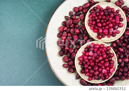 Fresh Frozen Cranberries and Dried Cranberries on Ceramic Plate Fresh Frozen Cranberries and Dried Cranberries on Ceramic Plate 139882352