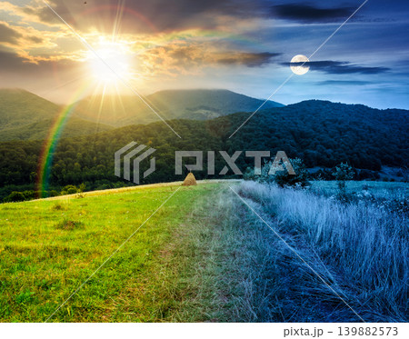 rural field on the hill. time change concept. view in to the valley at twilight. sun and moon over countryside mountain landscape. alpine pasture near forested hills. uncertainty and trust issues 139882573