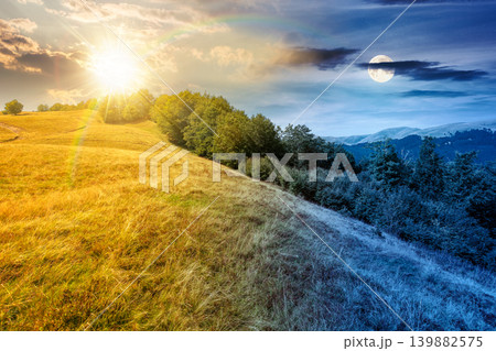 day meet night above carpathian mountain field. view of countryside landscape with valley behind the forest on the hill. sun and moon over clouds on a sky. autumn equinox background for astrology 139882575