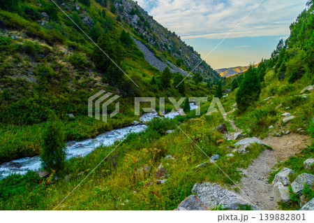 Scenic Mountain Valley with River and Hiking Trail at Sunset in Kyrgyzstan Scenic Mountain Valley with River and Hiking Trail at Sunset in Kyrgyzstan 139882801