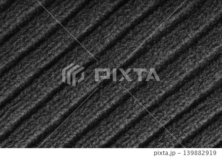 Black colored knitted fabric, knitwear texture with diagonal soft ribbed pattern background Black colored knitted fabric, knitwear texture with diagonal soft ribbed pattern background 139882919