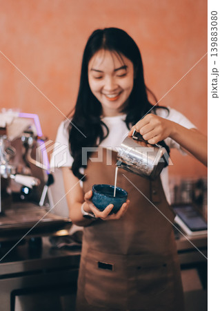Young woman at barista school learning how to make espresso coffee. Young woman at barista school learning how to make espresso coffee. 139883080