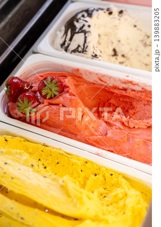 Ice cream set. Cold dessert. Bright color cold treat with different flavor in freezer. Sweets with strawberry garnish chocolate crumbs in shop. Ice cream set. Cold dessert. Bright color cold treat with different flavor in freezer. Sweets with strawberry garnish chocolate crumbs in shop. 139883205