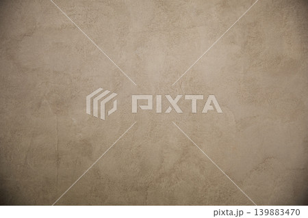 Beige textured concrete or plaster wall background with vignette 139883470
