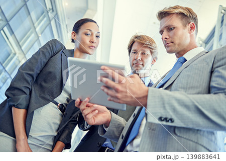 Business people, tablet and discussion for project in office, collaboration and unity for proposal. Coworkers, workplace and teamwork for reading a report, support and online for plan and networking Business people, tablet and discussion for project in office, collaboration and unity for proposal. Coworkers, workplace and teamwork for reading a report, support and online for plan and networking 139883641