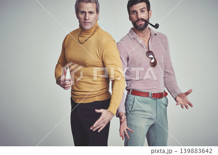 Portrait, men and serious with fashion in studio together in smart casual, clothes and style with smoking pipe and accessories. Fashionable, vintage and retro look with elegance and classy. Portrait, men and serious with fashion in studio together in smart casual, clothes and style with smoking pipe and accessories. Fashionable, vintage and retro look with elegance and classy. 139883642