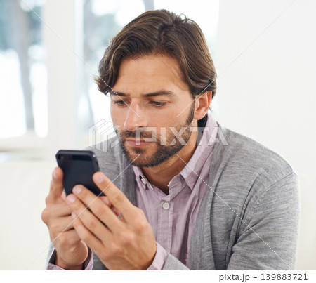 Phone, search and social media with business man in office for communication or networking. App, contact and information with serious young employee reading or typing text message in workplace Phone, search and social media with business man in office for communication or networking. App, contact and information with serious young employee reading or typing text message in workplace 139883721