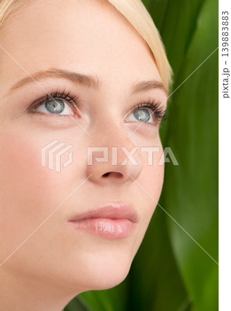 Face, beauty and woman with leaf for skincare isolated on green background for wellness, health or natural. Thinking, cosmetics or young model in nature for facial, organic and closeup of dermatology Face, beauty and woman with leaf for skincare isolated on green background for wellness, health or natural. Thinking, cosmetics or young model in nature for facial, organic and closeup of dermatology 139883883