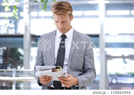 Businessman, reading and newspaper in office for headlines, morning print and corporate information in accounting. Accountant, news and current affairs on global finance and analysis in workplace Businessman, reading and newspaper in office for headlines, morning print and corporate information in accounting. Accountant, news and current affairs on global finance and analysis in workplace 139883948