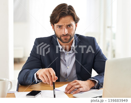 Desk, laptop and portrait of businessman with anger, paperwork and serious financial analyst in office. Consultant, business advisor or frustrated man with computer, documents and notes at startup. 139883949