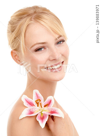 Beauty, flower and portrait of woman in studio with natural, health and wellness face routine. Cosmetic, skincare and person with floral plant for facial dermatology treatment by white background. Beauty, flower and portrait of woman in studio with natural, health and wellness face routine. Cosmetic, skincare and person with floral plant for facial dermatology treatment by white background. 139883971