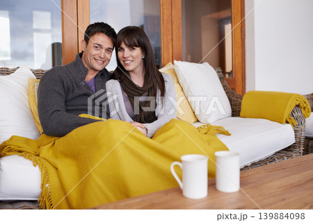 Happy, love and portrait of couple on a sofa with trust, support or bonding with coffee and blanket at home. Smile, face or people in living room with security, safety and chilling together in house Happy, love and portrait of couple on a sofa with trust, support or bonding with coffee and blanket at home. Smile, face or people in living room with security, safety and chilling together in house 139884098