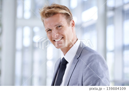 Happy businessman, portrait and lawyer at office with stylish suit for career ambition, start or job. Face of confident man employee with smile for business opportunity at corporate firm or workplace 139884109