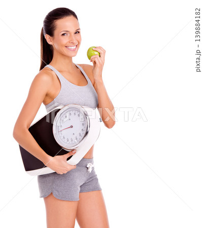 Scale, apple and portrait of woman in studio with snack for weight loss, health and wellness diet. Fitness, vitamins and female person eating organic, fresh and nutrition fruit by white background. Scale, apple and portrait of woman in studio with snack for weight loss, health and wellness diet. Fitness, vitamins and female person eating organic, fresh and nutrition fruit by white background. 139884182