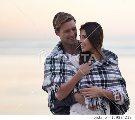 Couple, hug and sunset at beach with blanket for vacation, love and care in nature, outdoor and ocean. Man, woman and embrace with smile, bonding and happy for memory on holiday by sea in Australia Couple, hug and sunset at beach with blanket for vacation, love and care in nature, outdoor and ocean. Man, woman and embrace with smile, bonding and happy for memory on holiday by sea in Australia 139884218