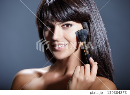 Beauty, skincare and portrait of happy woman with brush for makeup, facial and studio. Application, dermatology and cosmetics with face of girl isolated on grey background with smile, tools and blush Beauty, skincare and portrait of happy woman with brush for makeup, facial and studio. Application, dermatology and cosmetics with face of girl isolated on grey background with smile, tools and blush 139884278