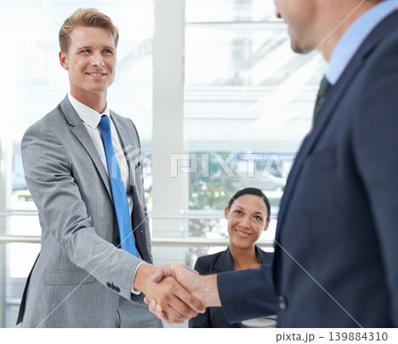 Handshake, collaboration and business people in office for deal, agreement or partnership. Smile, meeting and professional men shaking hands for company onboarding or hiring welcome in workplace. 139884310