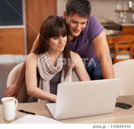 Couple, happy and laptop in kitchen with paper for budget, smile and coffee on table by pen. Partners, love and payment of apartment rent with technology, tax and online with connection from internet 139884350