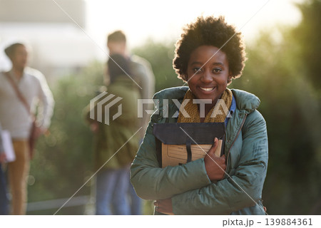 Black woman, university student and portrait with book on campus for prepare, information and notes on research. Outdoor, college and knowledge with advice for test and assignment submission. Black woman, university student and portrait with book on campus for prepare, information and notes on research. Outdoor, college and knowledge with advice for test and assignment submission. 139884361