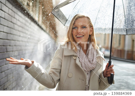 Woman, umbrella and hand with rain in city, walking and surprise for splash, weather and happy in winter. Person, wow and smile with travel, journey and excited with water on sidewalk in Cape Town Woman, umbrella and hand with rain in city, walking and surprise for splash, weather and happy in winter. Person, wow and smile with travel, journey and excited with water on sidewalk in Cape Town 139884369