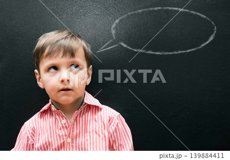 Child, boy and thinking with speech bubble on blackboard for creative idea, drawing and illustration in classroom. Student, kid and face with daydreaming, contemplating and question with chalkboard Child, boy and thinking with speech bubble on blackboard for creative idea, drawing and illustration in classroom. Student, kid and face with daydreaming, contemplating and question with chalkboard 139884411