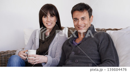 Love, portrait and happy couple relax on a sofa with trust support and bonding with morning coffee at home. Smile, face or people in living room with security, safety and chilling together in a house 139884476