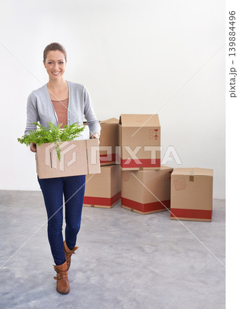 Portrait, new home and woman with boxes, moving and real estate with rental apartment and property. Person, plant and girl with achievement and personal development with package and house on a loan 139884496
