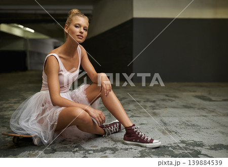 Ballet, fashion and portrait of woman with skateboard for edgy outfit, trendy sneakers and hipster style. Parking lot, modern aesthetic and ballerina on floor for dance hobby, sports or skating skill Ballet, fashion and portrait of woman with skateboard for edgy outfit, trendy sneakers and hipster style. Parking lot, modern aesthetic and ballerina on floor for dance hobby, sports or skating skill 139884539