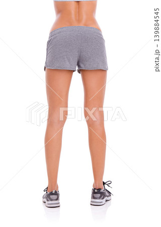 Woman, athlete and legs in studio with wellness for exercise, workout and healthy body with training shoes. Model, person and behind girl with sportswear and shorts for fitness on white background Woman, athlete and legs in studio with wellness for exercise, workout and healthy body with training shoes. Model, person and behind girl with sportswear and shorts for fitness on white background 139884545