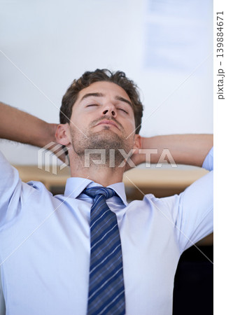 Businessman, eyes closed and calm breathing in office for stress management, relief and balance for peace while working. Man, relax and moment in workplace for wellness break for corporate work Businessman, eyes closed and calm breathing in office for stress management, relief and balance for peace while working. Man, relax and moment in workplace for wellness break for corporate work 139884671