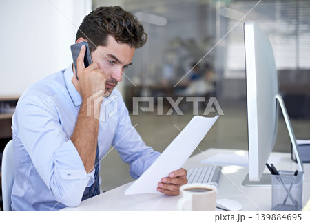 Businessman, reading and office for phone call, listening and computer in professional workspace. Male person, pc and research for startup, mobile and entrepreneur for career and project management 139884695