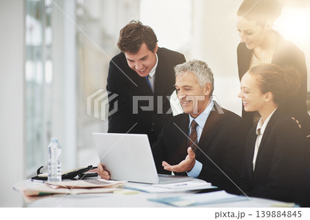 Employees, discussion and CEO with laptop in office, smile and technology on desk for planning. Colleagues, happy and talking to boss of workplace in corporate company for strategy and business 139884845