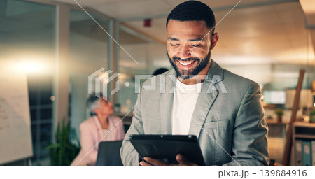 Tablet, meeting and happy business man in office, working on research project, schedule and planning. Night, corporate and worker on digital tech laugh for internet, website review and social media 139884916