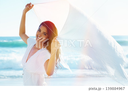 Woman, beach and portrait with fabric in wind for freedom, adventure or relax with smile in nature by ocean. Girl, person and happy with sarong on holiday, vacation and waves in sunshine in Indonesia Woman, beach and portrait with fabric in wind for freedom, adventure or relax with smile in nature by ocean. Girl, person and happy with sarong on holiday, vacation and waves in sunshine in Indonesia 139884967