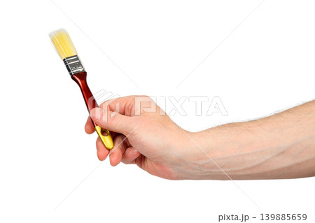 hand holds a brush with the handle down isolated on a white background hand holds a brush with the handle down isolated on a white background 139885659