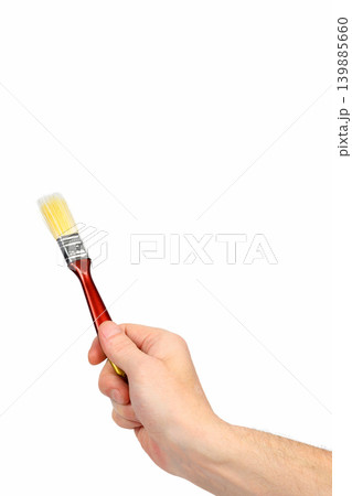 paint brush raised up in a hand isolated on a white background paint brush raised up in a hand isolated on a white background 139885660
